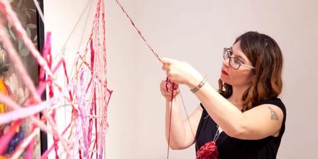 the artist Barbara Touati-Evans handcrocheting a web