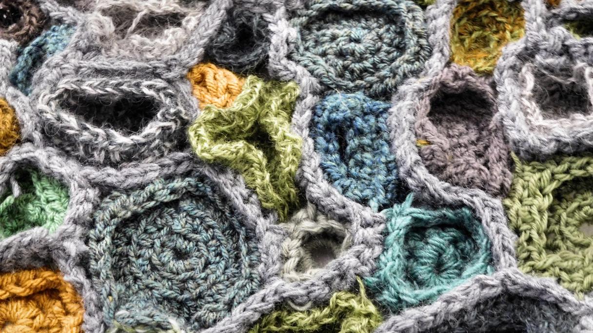 Close up of a crochet sculpture made of lots of semi spherical shapes